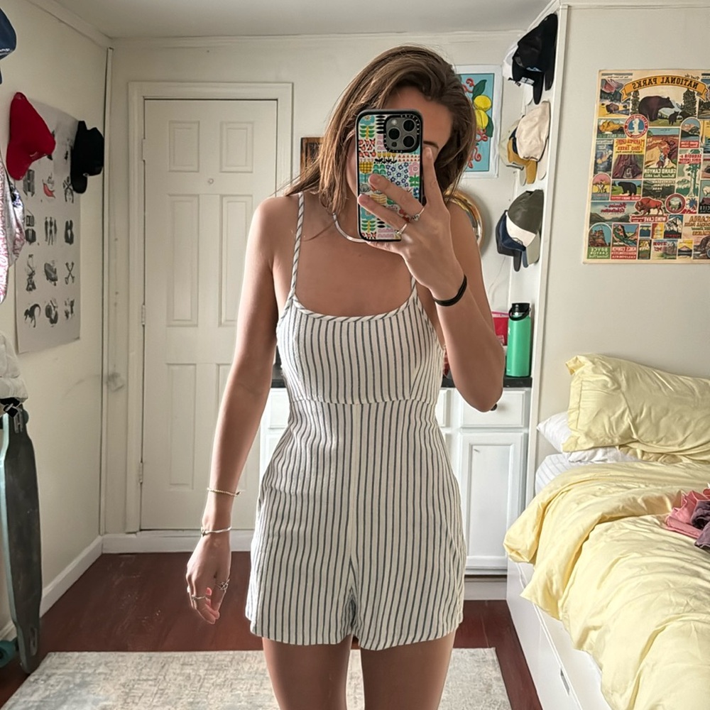 Billabong striped romper with adjustable straps and tie back.